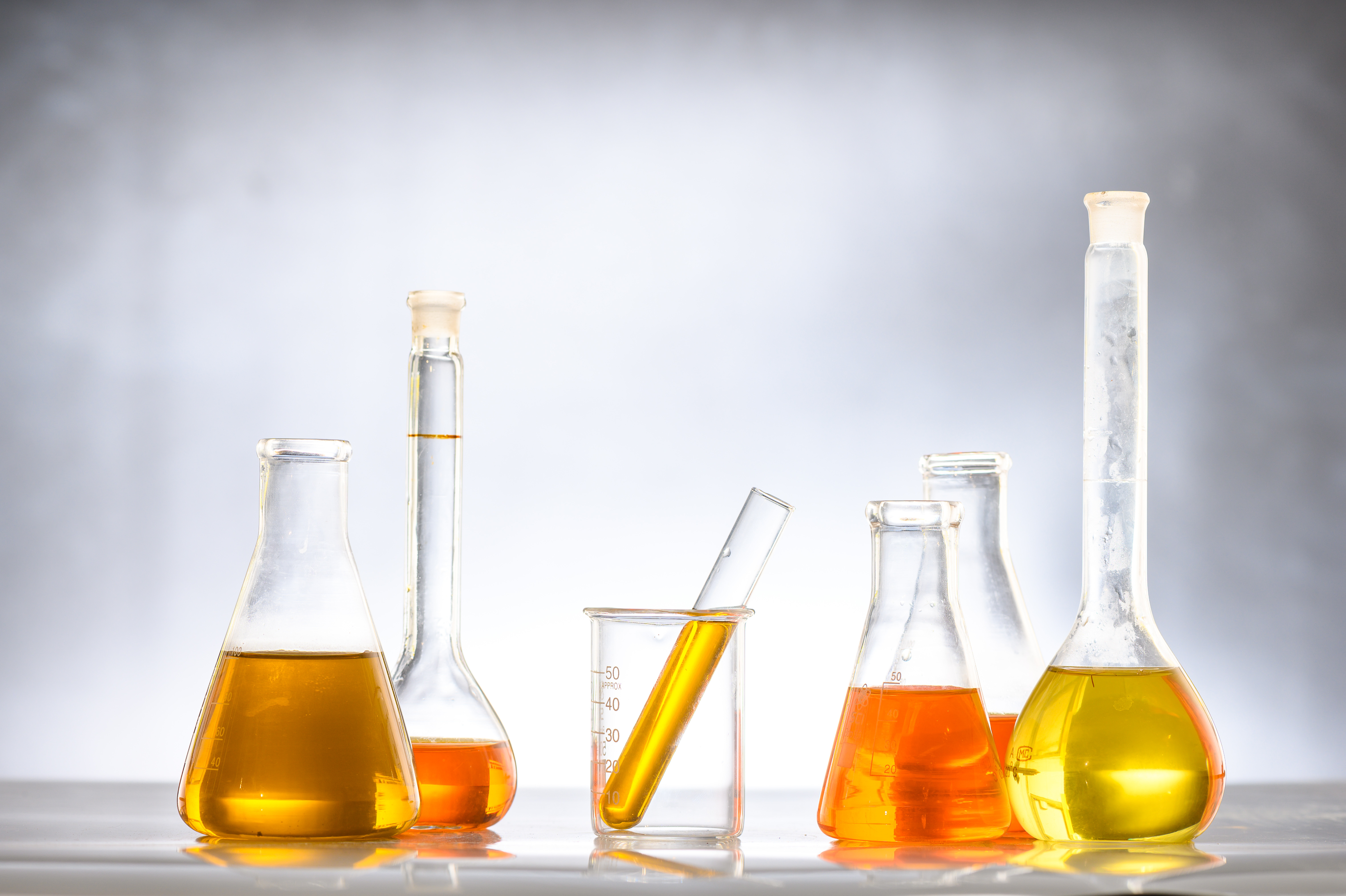Different types of diesel fuels in beakers including biodiesel and blended fuel