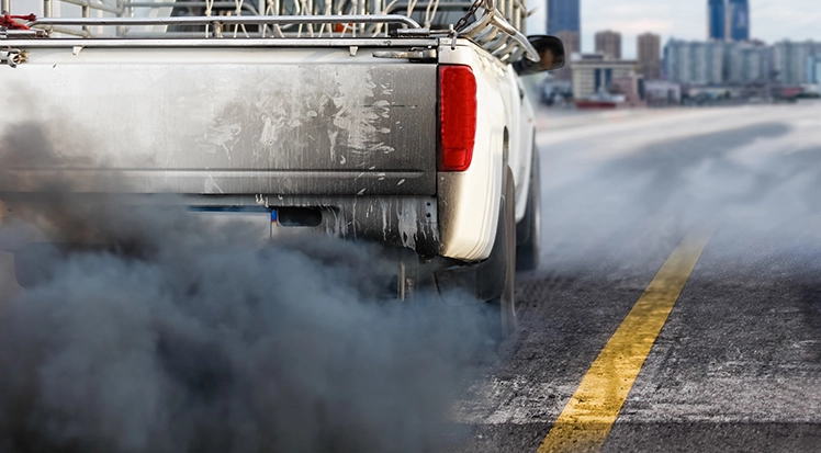 Untreated diesel pickup truck blowing black smoke from engine