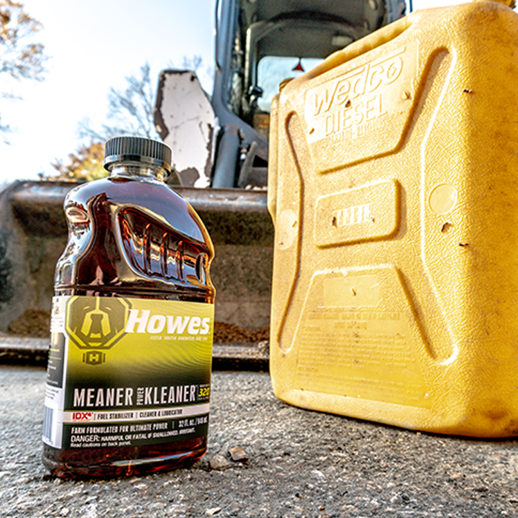 Howes Meaner Power Kleaner along side a diesel fuel storage container in front of a tractor