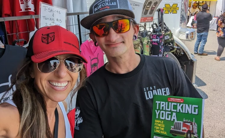 Hope Zvara with man holding her book entitled