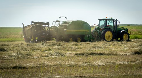 Farmer Haying in a Field with his Tractor